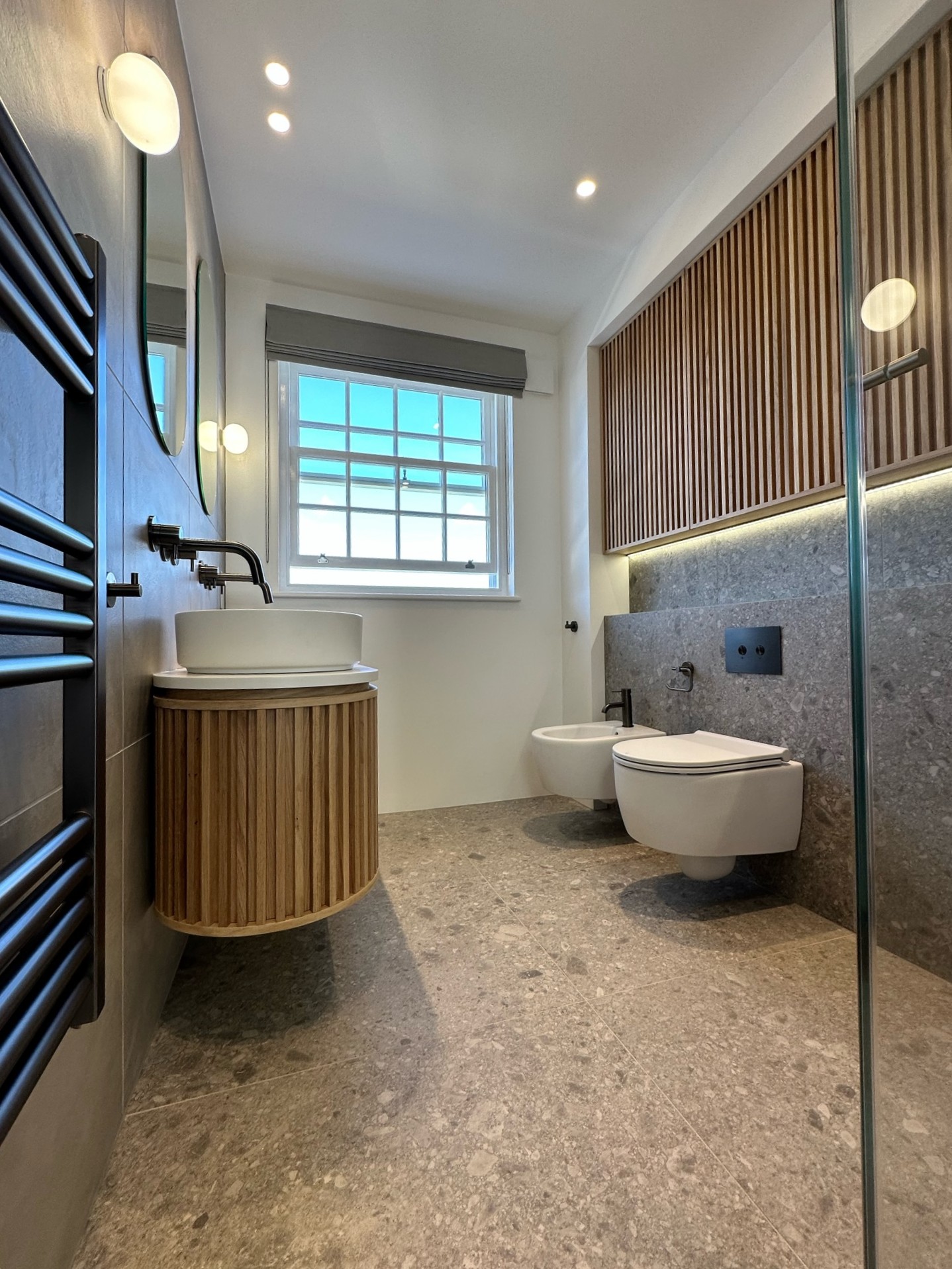 contemporary bathroom with timber slatted cabinets