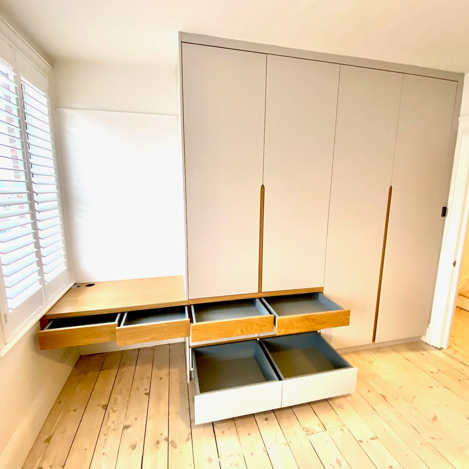 fitted wardrobes with integrated desk and drawers